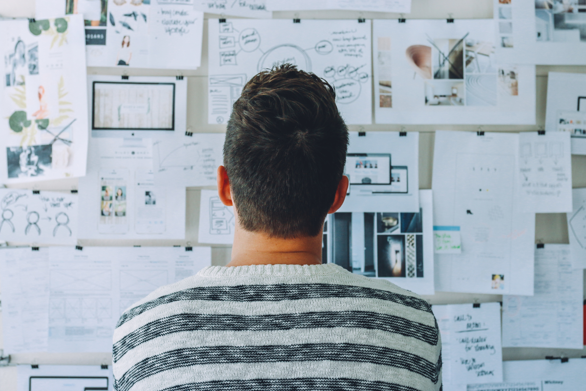 Man staring at a board of charts wondering "What is a High Control Religion"