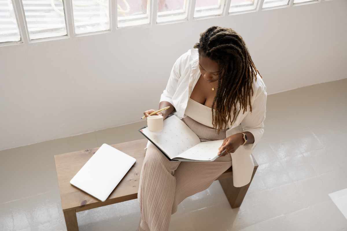 Featured image | black woman with calendar sitting on a bench