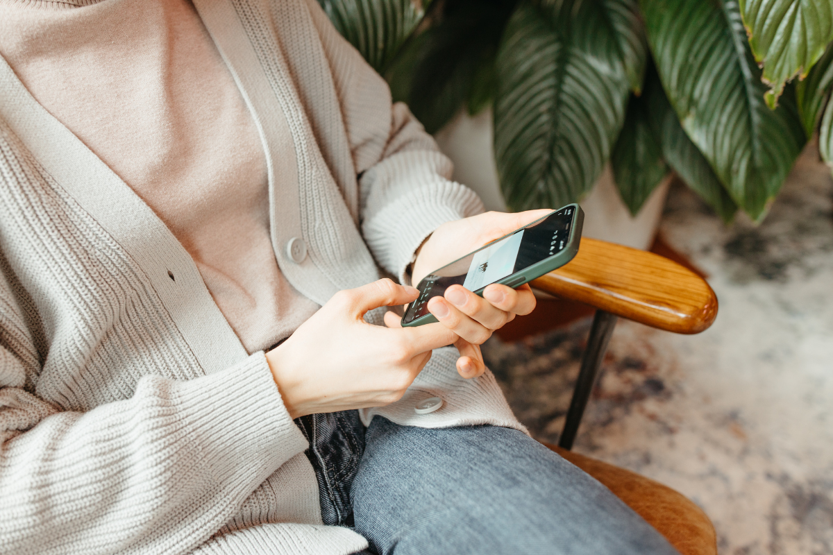 a person holding a phone and researching support to avoid spiritual bypassing