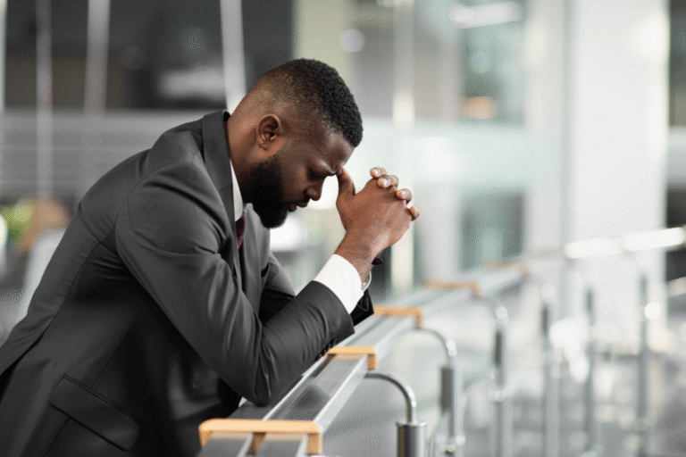 A man in a suit is praying.