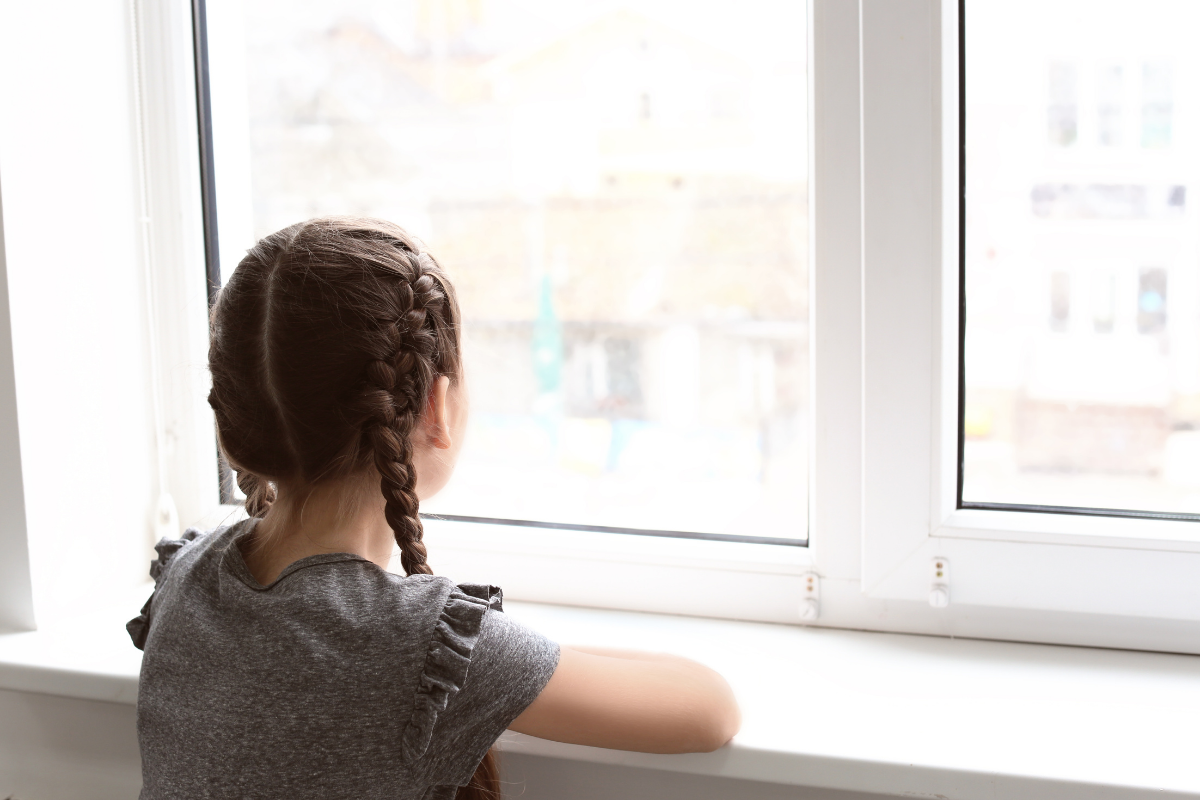 a girl looking out a window