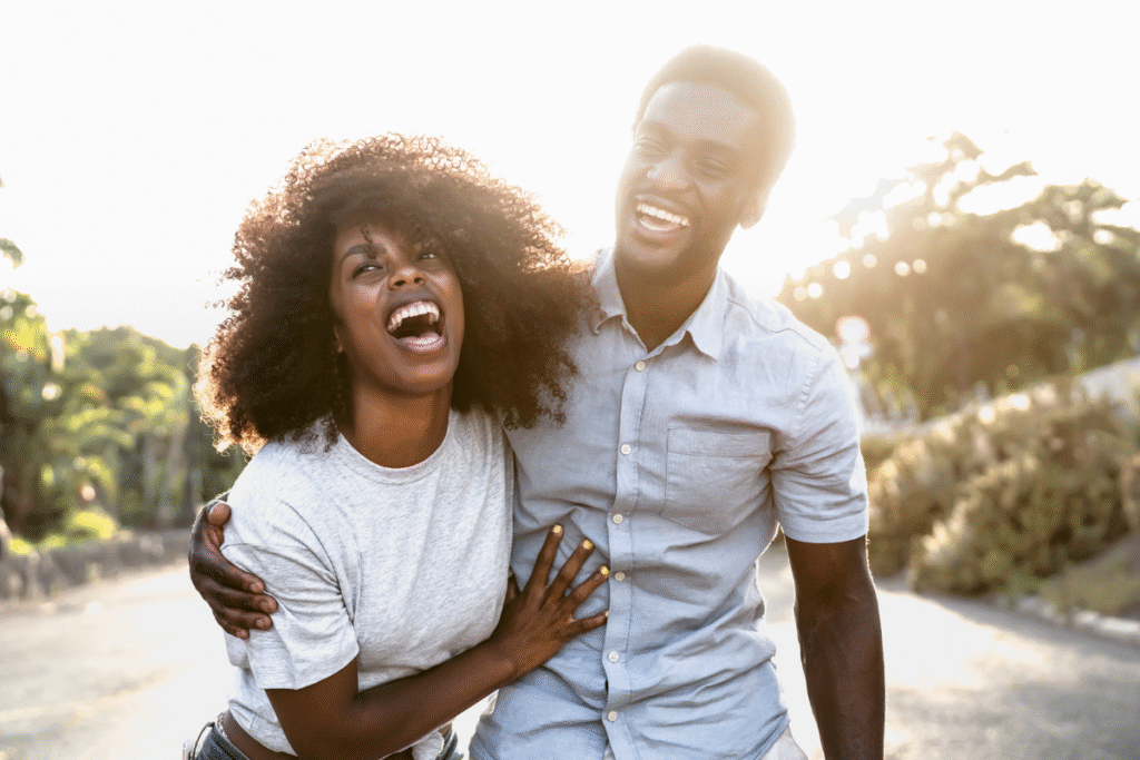 Man and woman laughing together after deprogramming from purity culture