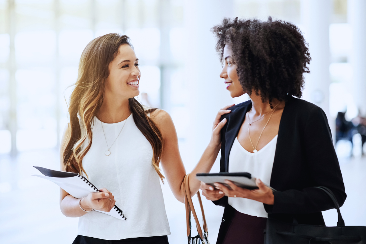 Woman with high-functioning religious trauma smiling and appearing confident with co-worker.
