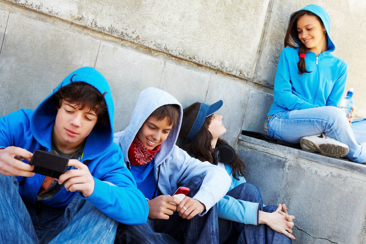 Group of friends in blue hoodies. One is labeled the black sheep in his religious family.